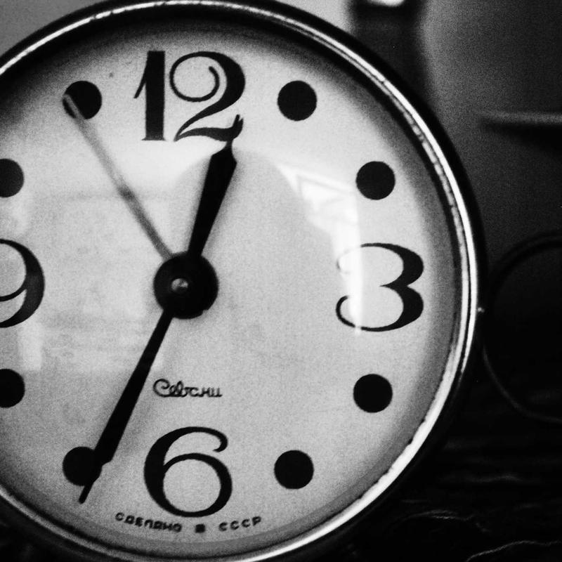 Close-up of an old black-and-white clock face