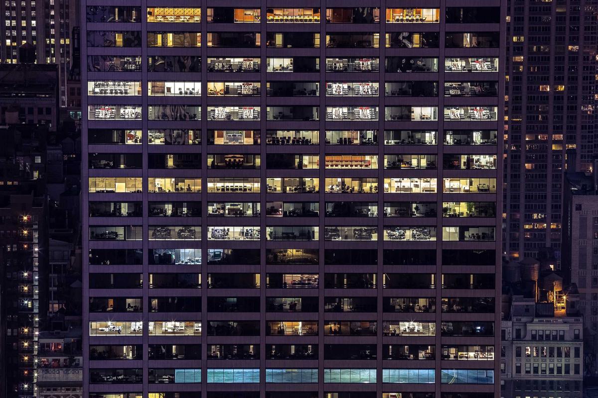 City tower windows lit up after dark