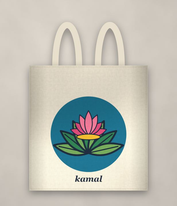 A cream canvas tote bag hand-painted with a pink lotus and green leaves on a peacock-blue circle, with the word kamal