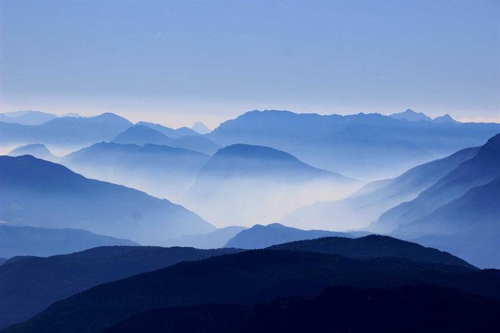 Layer upon layer of blue mountain ridges fading into haze